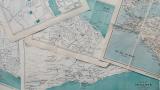 A photo of a stack of old maps. Photo taken by Annie Spratt
